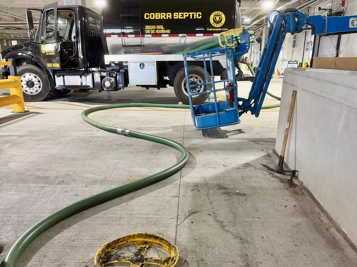 A Cobra Septic crew pumping a lift station in a parking garage
